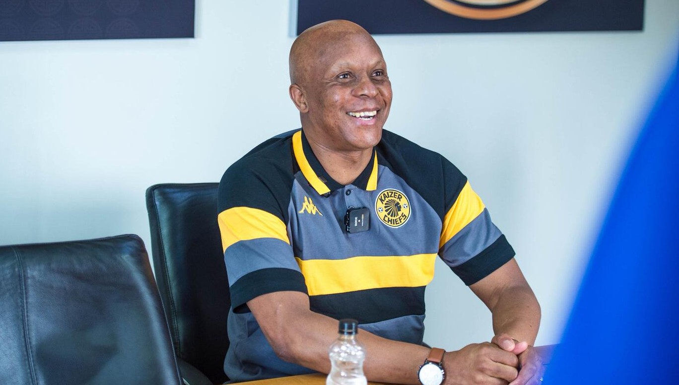 Doctor Khumalo smiling wearing a Kaizer Chiefs jersey.